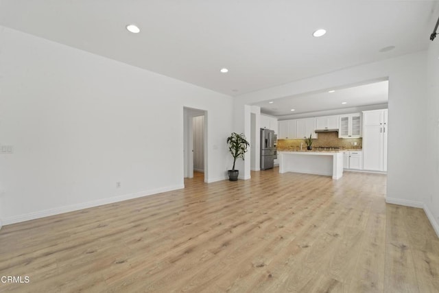 unfurnished living room featuring light hardwood / wood-style floors