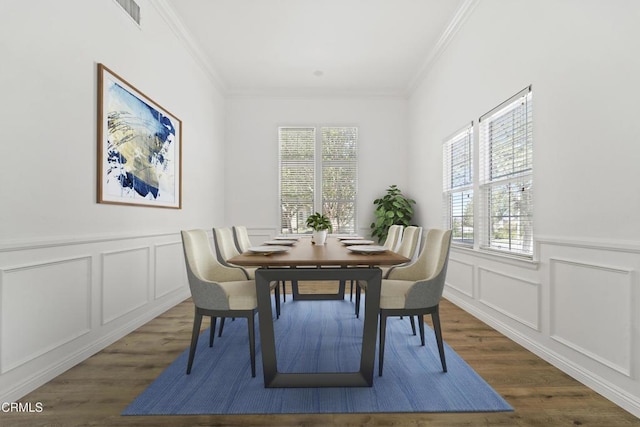 dining area featuring plenty of natural light, dark hardwood / wood-style flooring, and ornamental molding