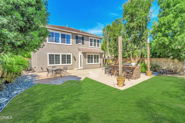 rear view of house featuring a patio area, exterior bar, and a lawn