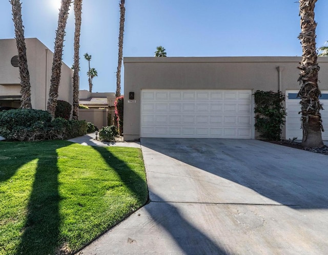 view of front facade featuring a front yard and a garage