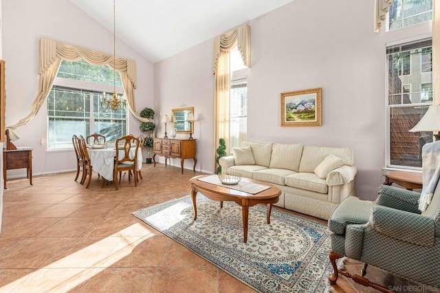 living room featuring high vaulted ceiling, tile patterned flooring, and an inviting chandelier