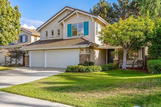 view of property featuring a front yard and a garage