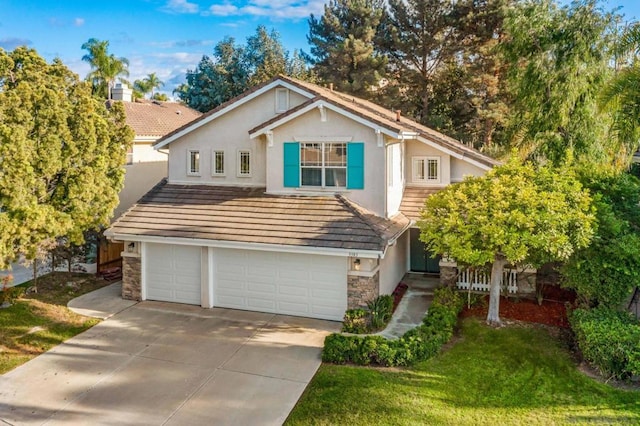 view of property featuring a front yard and a garage