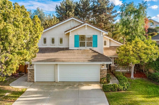 view of property featuring a front yard and a garage