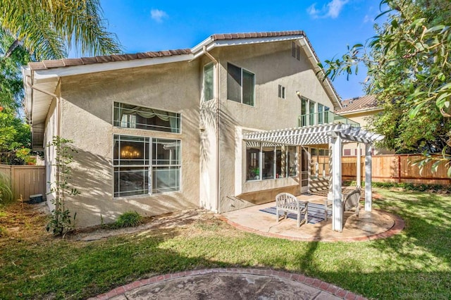 back of property featuring a patio area, a lawn, and a pergola