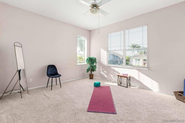 interior space with ceiling fan and carpet flooring