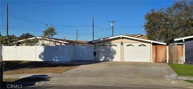 ranch-style house with a garage and an outdoor structure