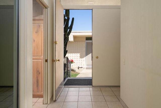 hall featuring light tile patterned flooring