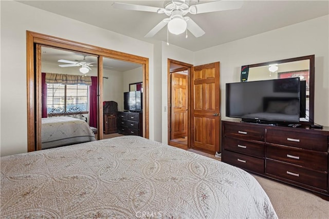 bedroom with ceiling fan and light carpet