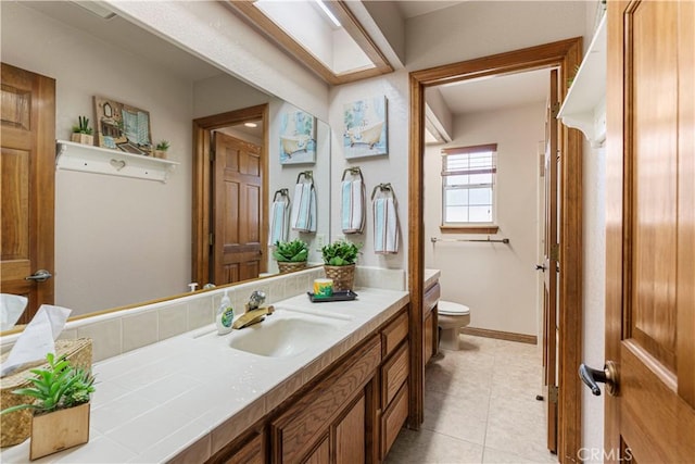 bathroom featuring toilet, tile patterned flooring, and vanity