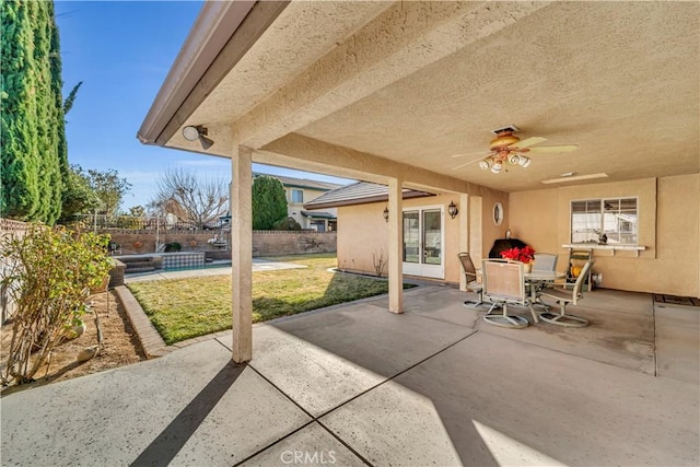 view of patio featuring ceiling fan and a swimming pool