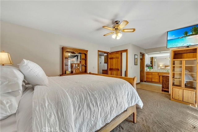 bedroom with light carpet, ceiling fan, and ensuite bathroom