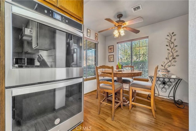 dining area featuring ceiling fan, light hardwood / wood-style floors, and plenty of natural light