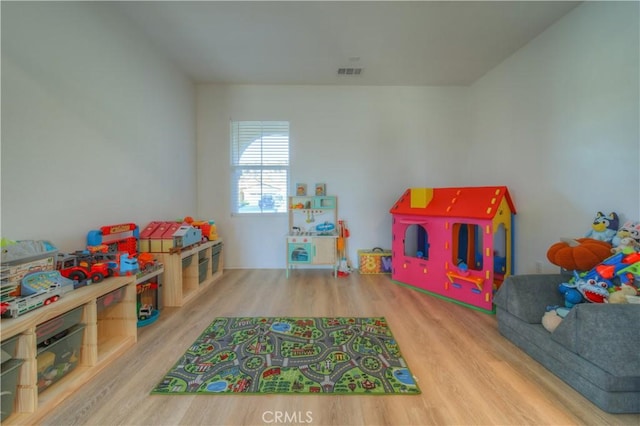 rec room with hardwood / wood-style floors