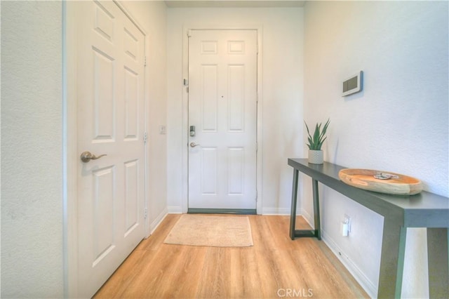 doorway with light wood-type flooring