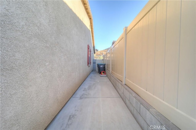 view of property exterior with a patio area