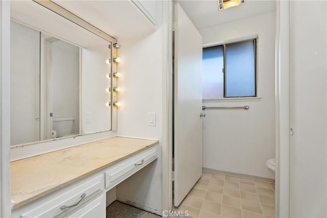 bathroom with toilet and vanity