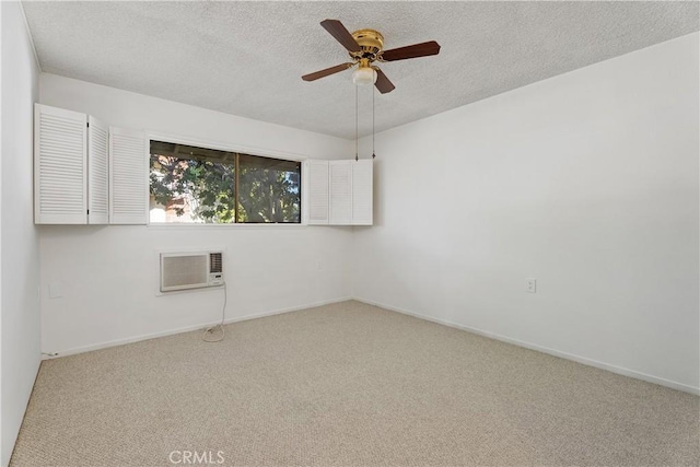 carpeted spare room featuring an AC wall unit, a textured ceiling, and ceiling fan