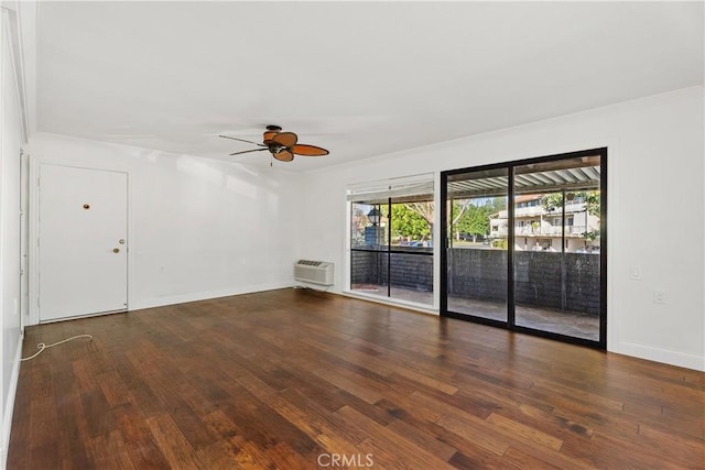 unfurnished room featuring an AC wall unit, ceiling fan, and dark hardwood / wood-style floors