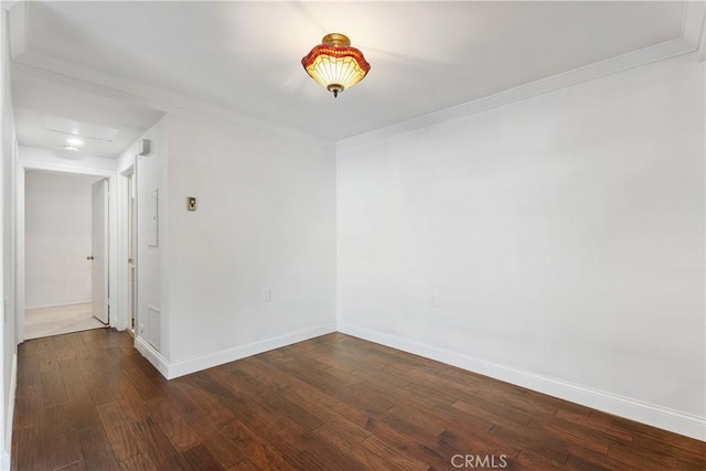 unfurnished room with ornamental molding and dark hardwood / wood-style floors