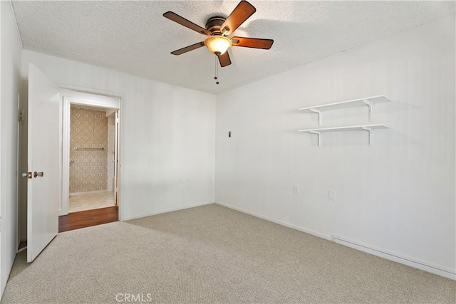 carpeted empty room with a textured ceiling and ceiling fan