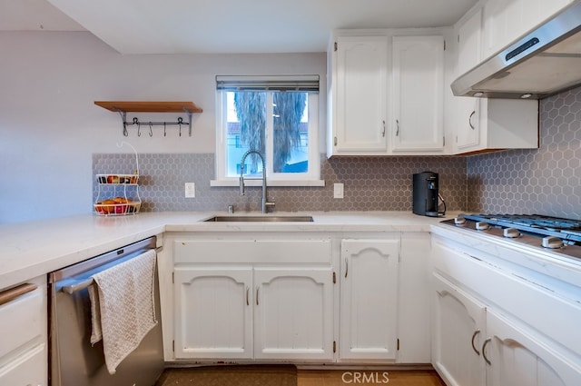 kitchen featuring sink, tasteful backsplash, dishwasher, and ventilation hood