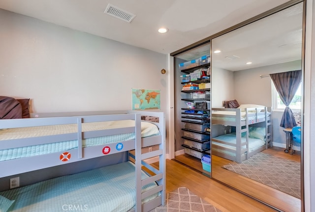 bedroom with hardwood / wood-style floors