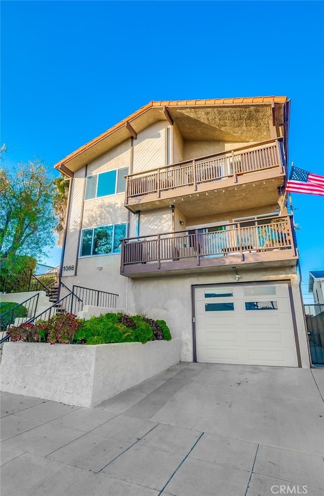 view of front of house with a balcony and a garage