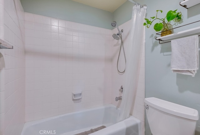 bathroom featuring shower / bath combo and toilet