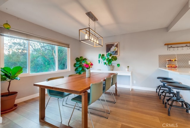 dining area featuring light wood-type flooring and a chandelier