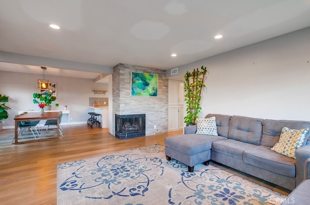 living room with a fireplace and light hardwood / wood-style floors