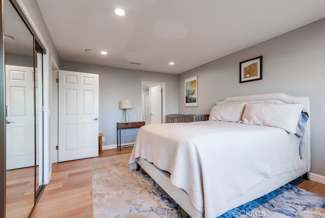 bedroom with light wood-type flooring and a closet