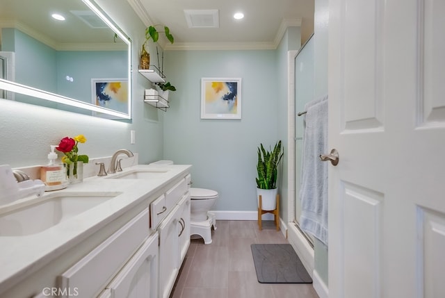 bathroom featuring toilet, ornamental molding, walk in shower, and vanity