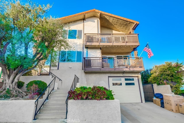 view of front of property with a balcony and a garage