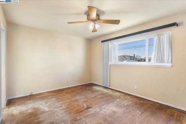 empty room with hardwood / wood-style floors and ceiling fan