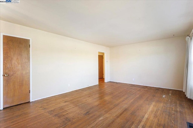 spare room with hardwood / wood-style flooring