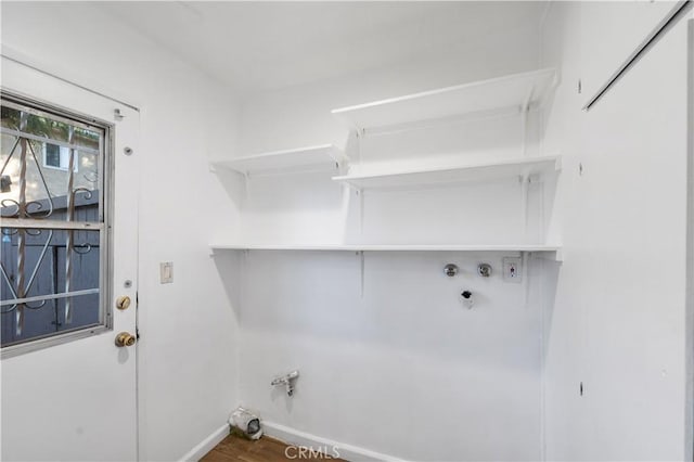 clothes washing area with hookup for a gas dryer and hardwood / wood-style floors