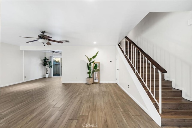 unfurnished living room featuring hardwood / wood-style flooring and ceiling fan