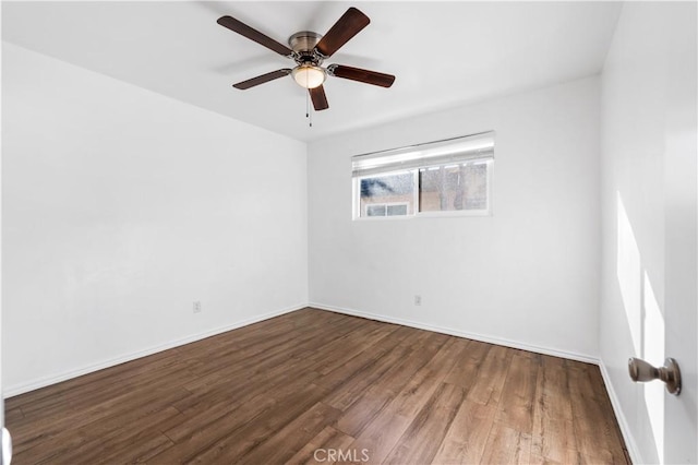 empty room featuring ceiling fan and hardwood / wood-style flooring