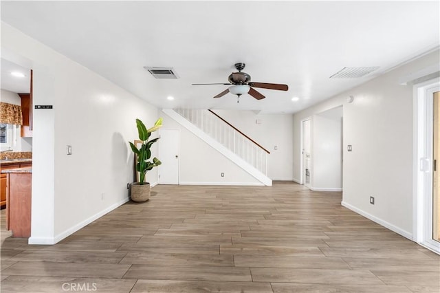 unfurnished living room with ceiling fan and light hardwood / wood-style flooring