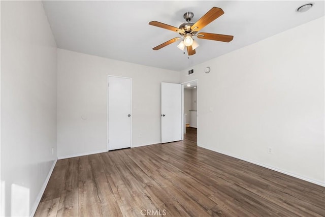 unfurnished room with ceiling fan and dark hardwood / wood-style floors