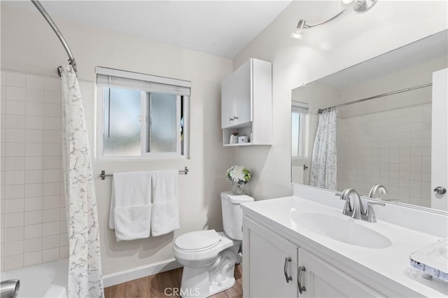 full bathroom with toilet, vanity, hardwood / wood-style floors, and shower / bathtub combination with curtain