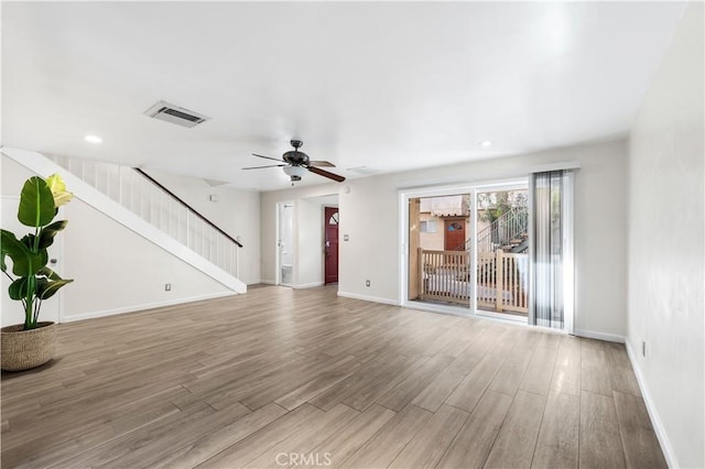 unfurnished living room with wood-type flooring and ceiling fan