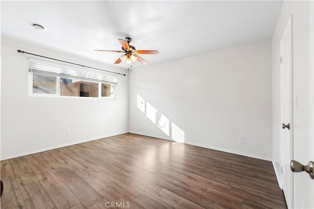 unfurnished room with ceiling fan and hardwood / wood-style floors