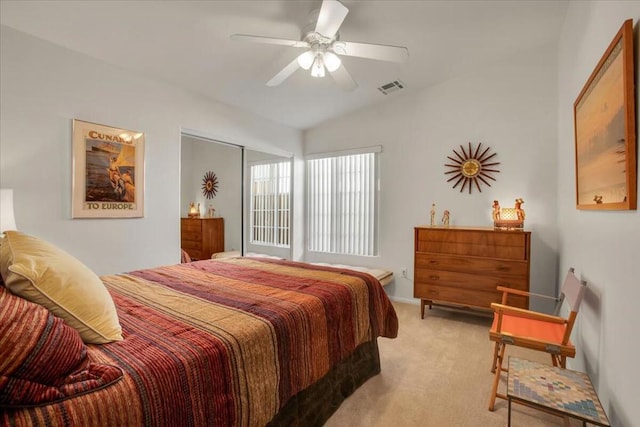 bedroom featuring ceiling fan, vaulted ceiling, and light carpet