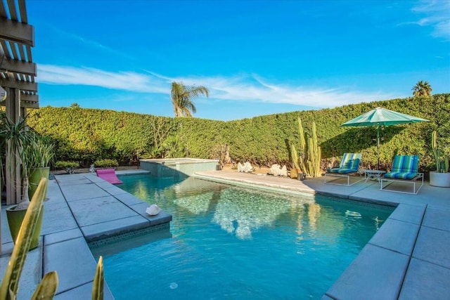 view of swimming pool with a jacuzzi and a patio