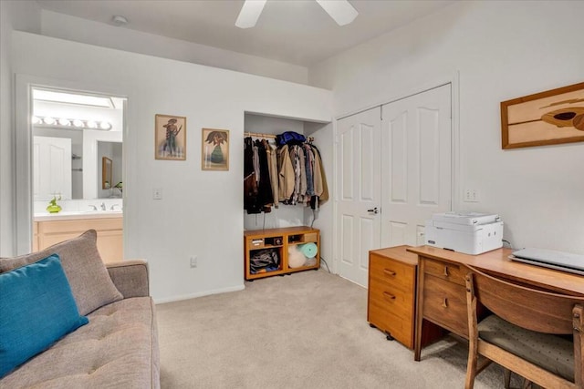 office space with ceiling fan, sink, and light colored carpet