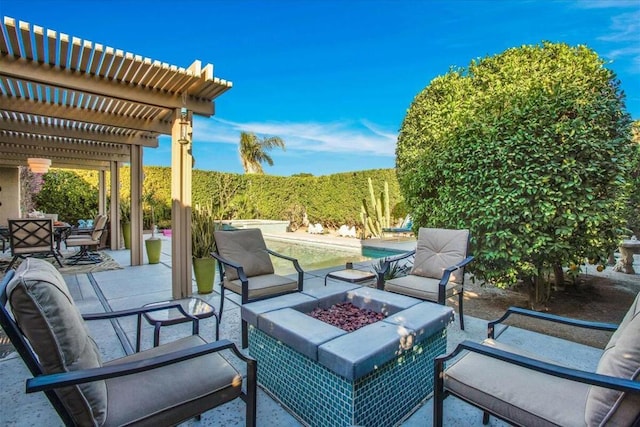 view of patio / terrace with a pergola and a fire pit