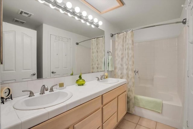 bathroom featuring tile patterned floors, shower / tub combo, vanity, and backsplash