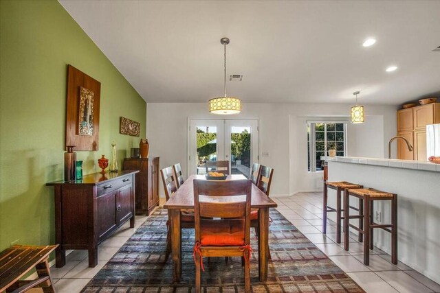 tiled dining area with french doors and vaulted ceiling